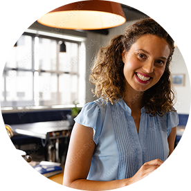Female professional with curly hair using digital tablet at workplace